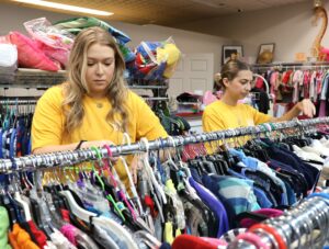 Tusculum students work in the clothing area of Opportunity House Thrift Store.