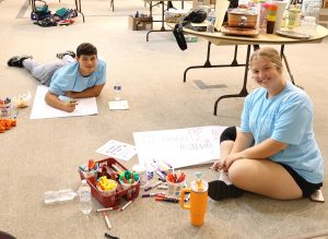 Students help First Presbyterian Church prepare for its rummage sale.