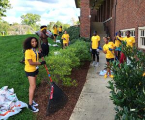Tusculum students perform landscaping at the Meen Center on campus.