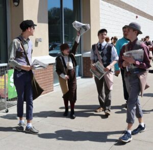 Newsies offer copies of The Greeneville Sun at the Greeneville Commons.