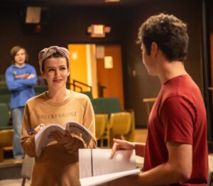 Rachel Lawrence, middle, who plays the female lead, rehearses a scene with Todd Wallin, right, who plays the male lead. Photo from Kristin Girton