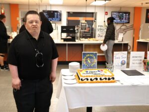 Travis Parton stands beside the cake made for his anniversary.