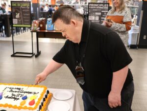 Travis Parton cuts his anniversary cake.