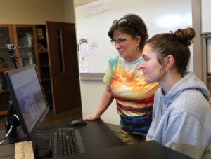 Dr. Susan Monteleone, left, and Tusculum student Maddie Creswell look at the Peace Corps website in one of the university’s classrooms.