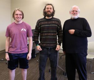 Joseph Medeck, who oversaw the chess tournament stands with the two winners, who tied. They are Evan Patrick in the middle and David Fischler on the right.