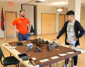 Dr. Nick Davidson, left, one of Pioneer Con’s organizers, plays a fellow competitor in Warhammer 40K.