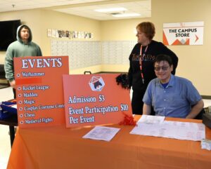 Dr. Harold Branstrator, right, one of the organizers, sits at the registration table. Helping him at Pioneer Con are his wife, Janet, middle, and student Joseph Cole.