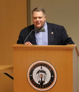Edward Roberts emphasizes impact and investment in his remarks.
