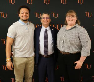 Dr. Scott Hummel, middle, takes time for a photo with students Aidan Dark, left, and Jaida Ellison.