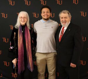 Student Aidan Dark, middle, joins Marilyn duBrisk, left, and Wess duBrisk for a photo.