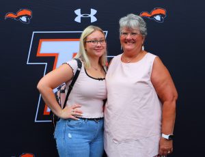 Incoming student Tara Kilgore, left, enjoys a photo with a family member.