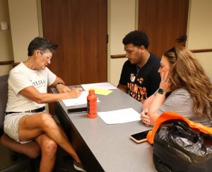 Dr. Suzanne Byrd, left, advises Eli Davis, middle, during Friday’s Pioneer Quest.