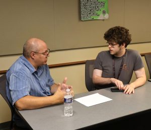Walter Wimberly, left, a computer science professor, speaks with Kodi Oliver, who will pursue a degree in that subject.