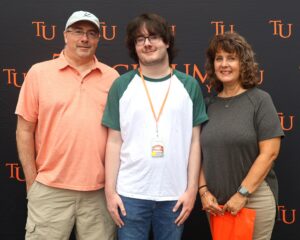 New student Collin Keasling, middle, takes a photo with his family.