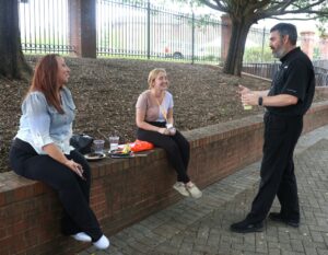 New student Jennifer Holbrook, center, speaks with Dr. Chuck Pearson, right, chair of the Natural Sciences Department.