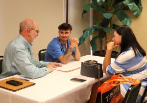 Dr. Amiel Jarstfer, left, speaks with incoming student Jaxson Archer, middle, during Pioneer Quest.