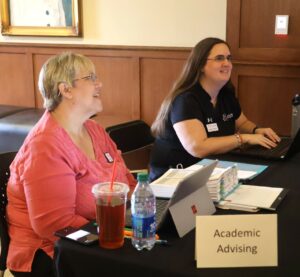 Jill Oberfeitinger, left, director of academic advising, and Bobbie Clarkson, assistant athletic director for academics, assist students with their course registration.