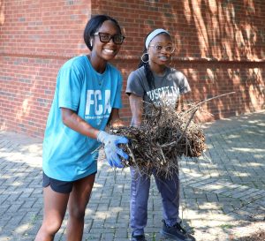 Saniah Atchison, left, and Zy’Moria Woodmore show some of the landscaping work they completed during Freshman Day of Service.