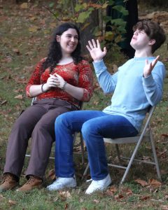 Two actors play a scene during a play at the 2024 production.