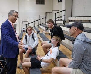 Dr. Scott Hummel, left, speaks with current and incoming students and a parent.