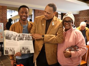 Bill Edmonds, middle, shows his photo in a Tusculum yearbook. He is joined by his daughter, Elise, and grandson, Tai.