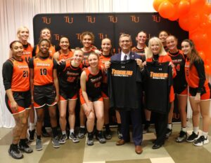 Tusculum’s women’s basketball team presented T-shirts to Dr. Scott Hummel and Starr Hummel.