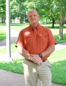 The Rev. E.J. Swatsell stands on campus.