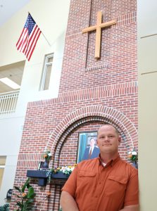The Rev. E.J. Swatsell stands in the Scott M. Niswonger Commons.