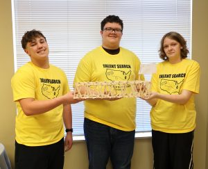 The first place team in the bridge-building competition shows its creation.