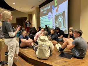 Sandi Bible, left, speaks with Talent Search students at a program to prepare them for high school.