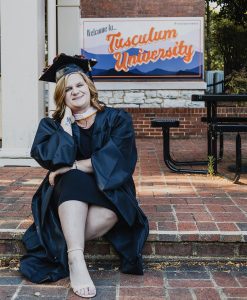 Elizabeth Tarlton poses on campus in her cap and gown. Photo by Hannah Vaughn
