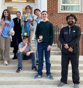 Members of the quiz bowl team from University School of Nashville pose with Dr. Mukherjee, right, following an earlier competition. Most of the students in the photo are members of Team Tennessee.