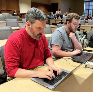 Dr. Chuck Pearson, left, prepares to help run a game at the Tusculum Earlybird.