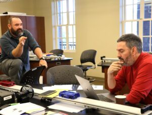 Dr. Chuck Pearson, right, and Dr. Peter Noll discuss an item about the Tusculum Earlybird.