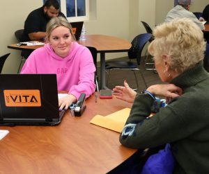 Brynn Stokes, left, prepares an income tax return at the Meen Center in 2025.