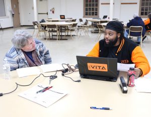 Terrick Ponds, right, prepares an income tax return in Johnson City.