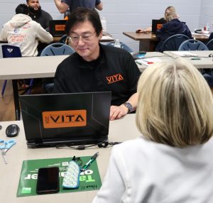 Dr. Harold Branstrator assists with an income tax return preparation.