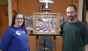 Two of the participants show off their painting at the 2024 Valentine’s Painting Night.