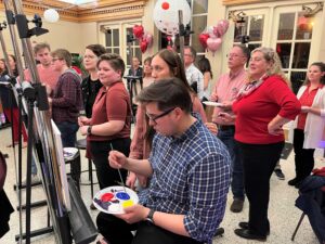 Guests listen to guidance as they create their paintings in 2023.