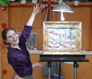 Tusculum student Emme Foster displays her painting at the end of the 2024 event.