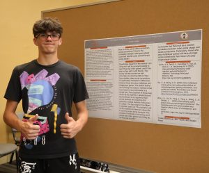 Parkar Collins stands by his poster during the presentations.