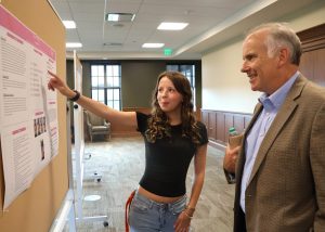 Abagail Taylor, left, discusses her poster with Dr. David Smith.