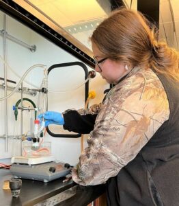 Skylar Lane works on the anti-cancer drug research project in a lab at the Meen Center on campus.