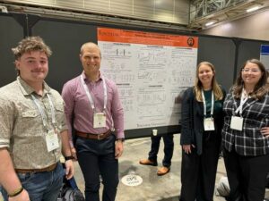 Left to right, Konrad Sehler, Dr. Dennis Ashford, Keylon Reynolds and Skylar Lane present a poster on the anti-cancer drug research project at the American Chemical Society conference in New Orleans earlier this year.