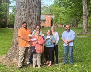 Holding the check are Jordan Baker, left, and Vivian Gibbons. The remaining participants in the ceremony are, left to right, Kim Carter, Dr. Heather Henson-Ramsey, Pam Leisner and Dr. Peter Noll.