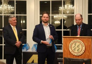 A.J. Kaufmann, right, managing editor of The Business Journal of Tri-Cities Tennessee/Virginia, discusses the qualities of Dr. Nick Davidson, center, as Bill Derby, one of the magazine’s owners, listens.