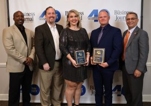Left to right, Chuck Sutton, Dr. David Cook, Erin Frizzell, the Rev. E.J. Swatsell and Dr. Scott Hummel celebrate after the event.