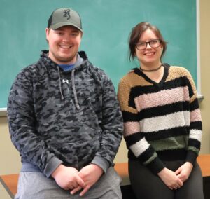 Tate Haugen, left, and Kiersten Paxton celebrate their recognition in one of Tusculum University’s English classrooms.