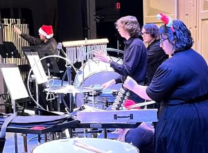 The percussion section performs at a prior Christmas concert.