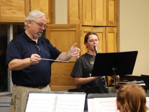 Sabrina Nelson right, rehearses her solo with the band as Chris Chambers conducts.